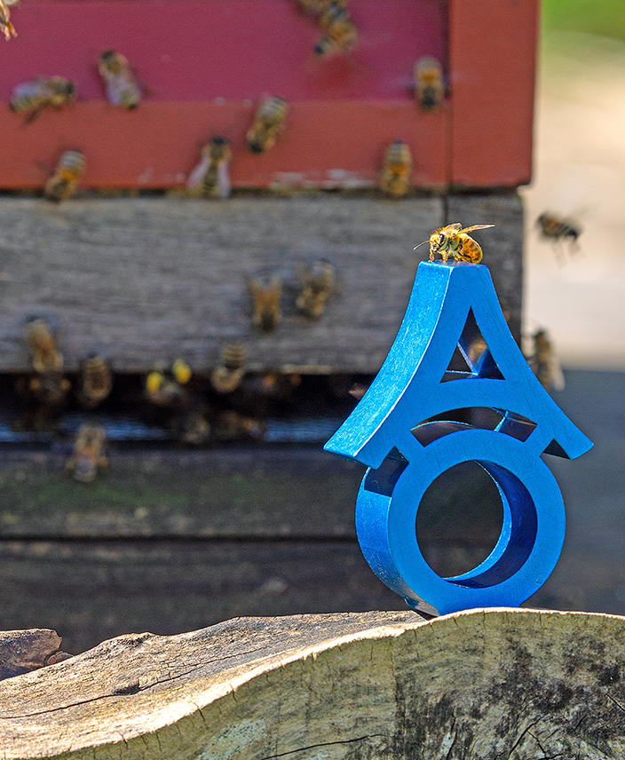 ALUwerk – Bienen am Bienenstock und auf einem ALUwerklogo